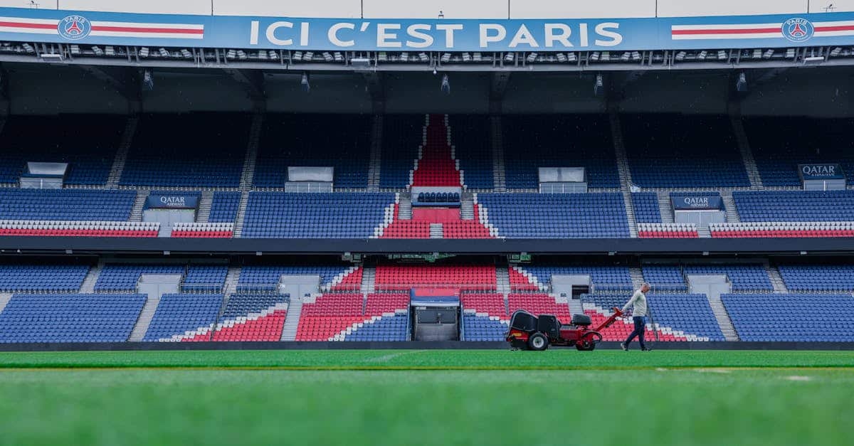 Gardener working on the field at Parc des Princes stadium, Paris. Vibrant and iconic sports venue.